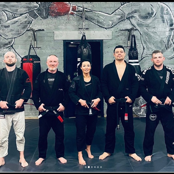 Simon and teammates in their black belts at the February 2023 ironman