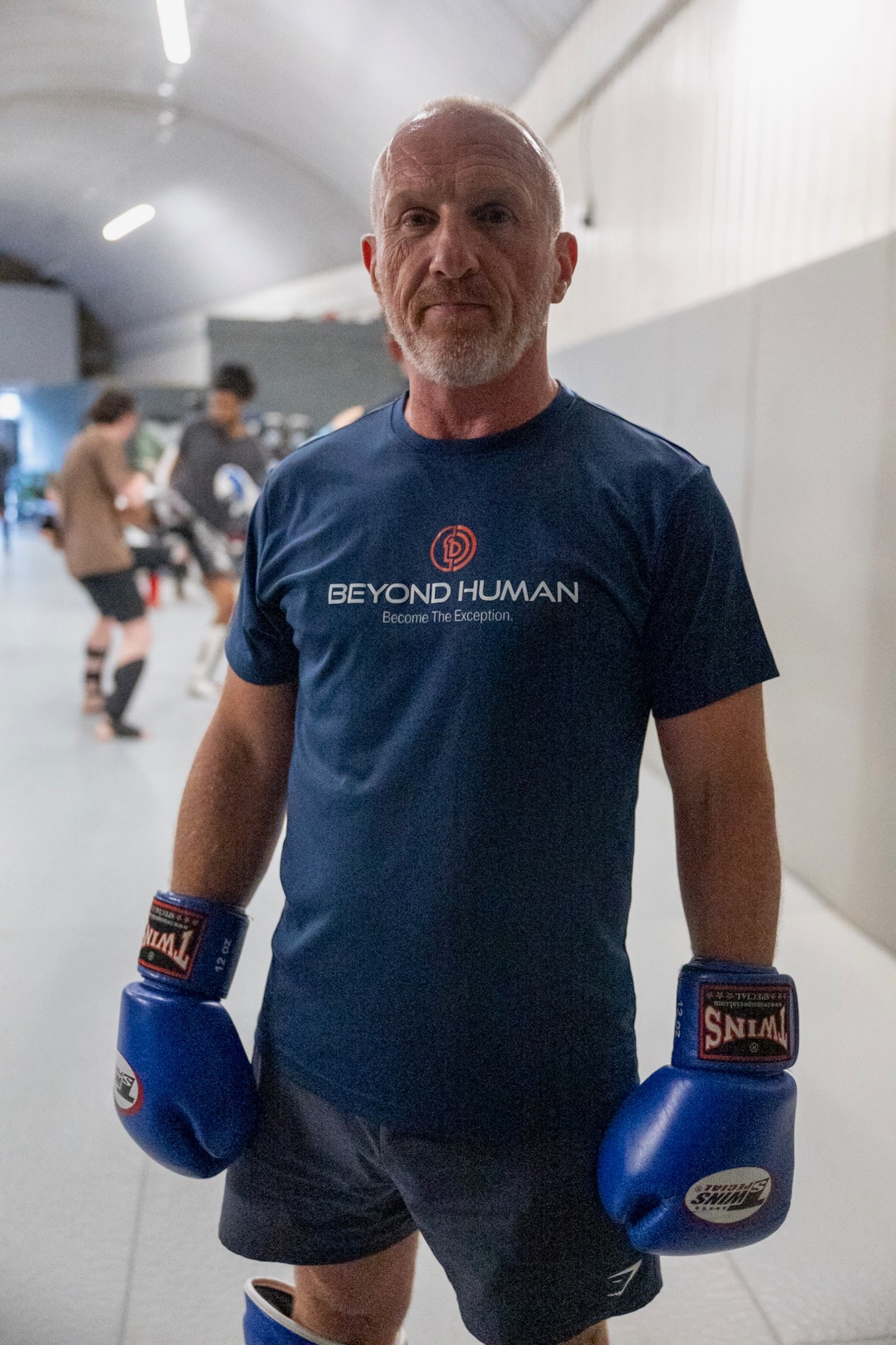 Simon Kenny wearing his Beyond Human T-shirt and boxing gloves at SBG Manchester